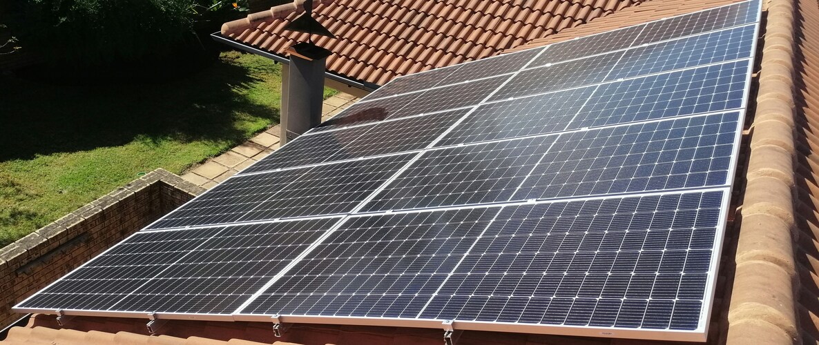 Solar compliance South Africa — rooftop solar panels on a residential property with clear blue sky